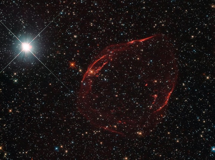 This Hubble image shows the remnant of a small, very dense s…