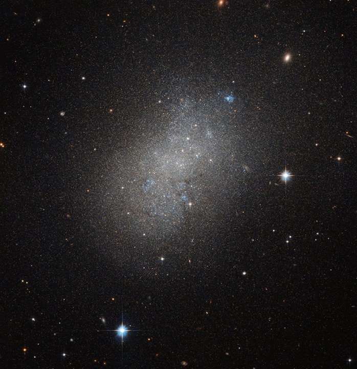 Stars appear to create a misty fog in this Hubble Space Tele…