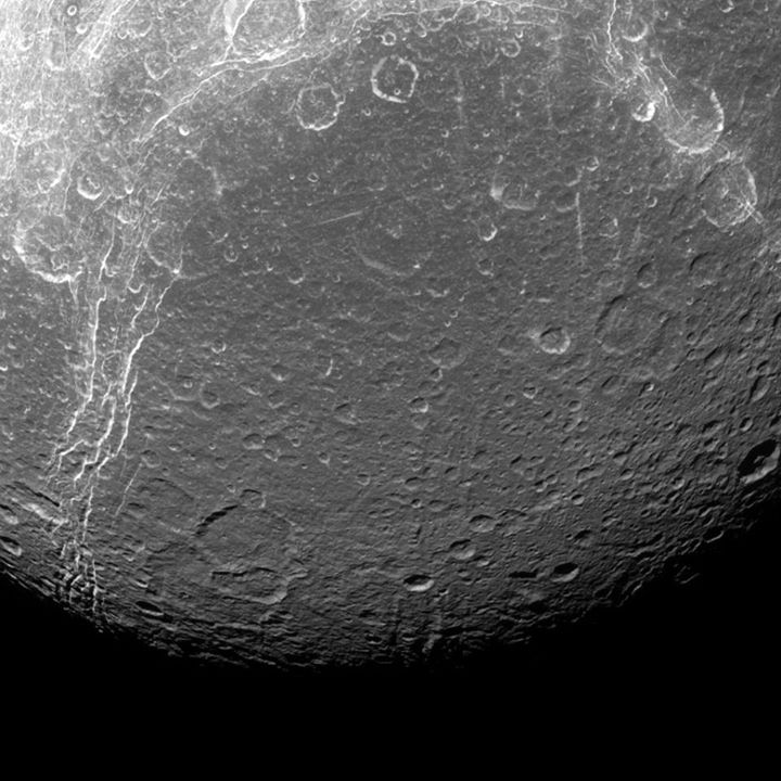 Saturn’s fourth largest moon, Dione, reveals its past via contrasts in this view…