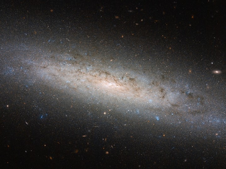 This shining disc of a spiral galaxy is NGC 24, discovered by British-German ast…