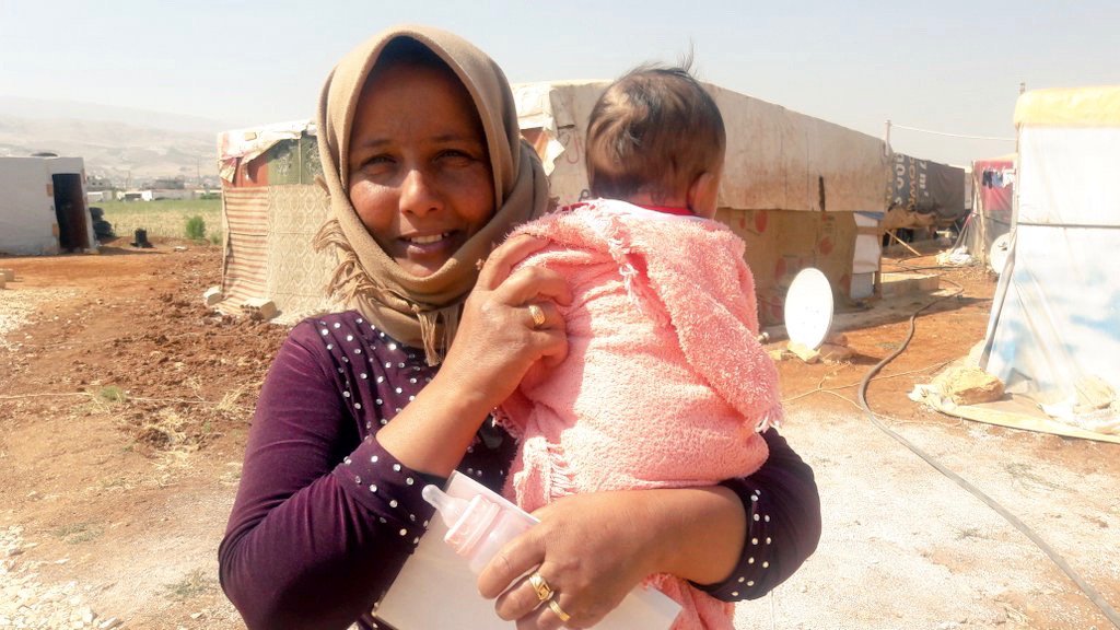 Syrian refugee Ghamadnar with her 2-month-old son Ali in an informal settlement …