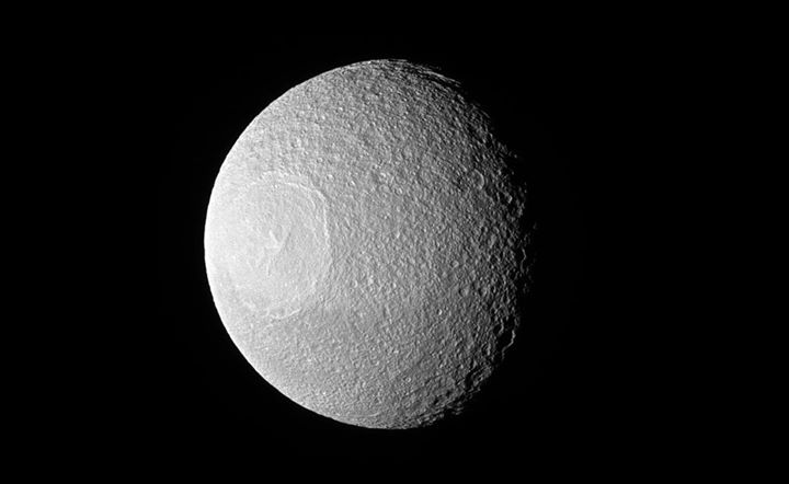 Saturn’s moon Tethys may look like an eyeball staring off in…