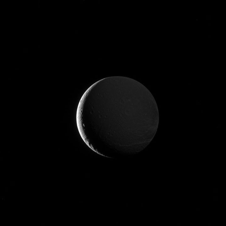 Seen by the international Cassini mission, Dione’s lit hemisphere faces away fro…