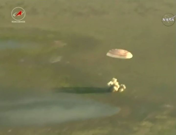 The moment of Soyuz MS-03 touchdown seen from above by a circling recovery helic…