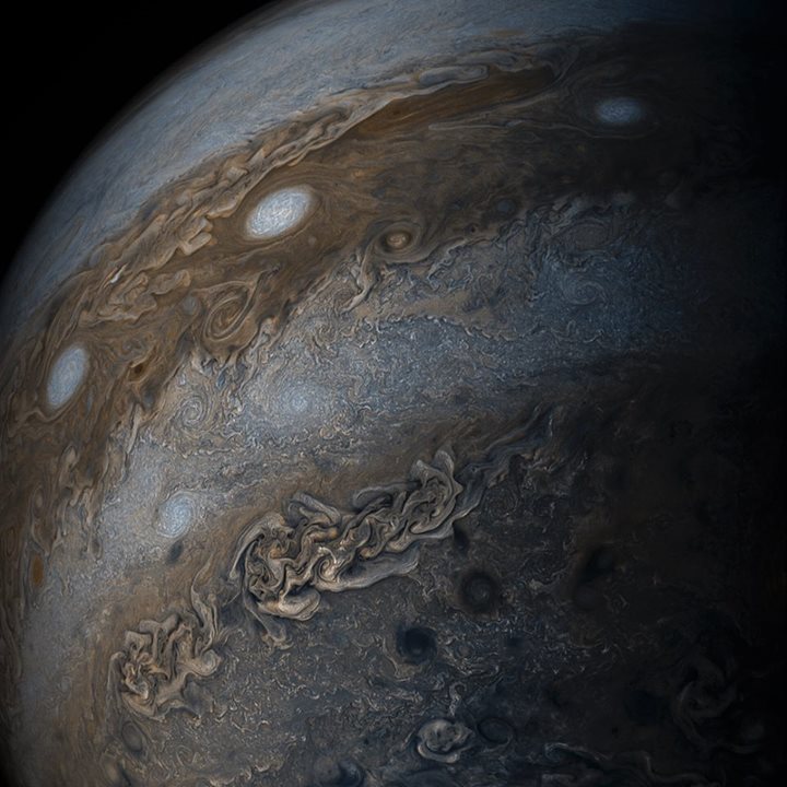Swirling bands of light and dark clouds on Jupiter are seen …