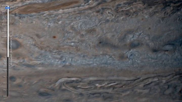 A raging storm 1.3 times as wide as Earth churns on Jupiter’…