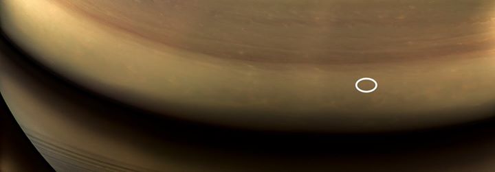 That tiny oval amid the swirling, stormy clouds of Saturn, s…