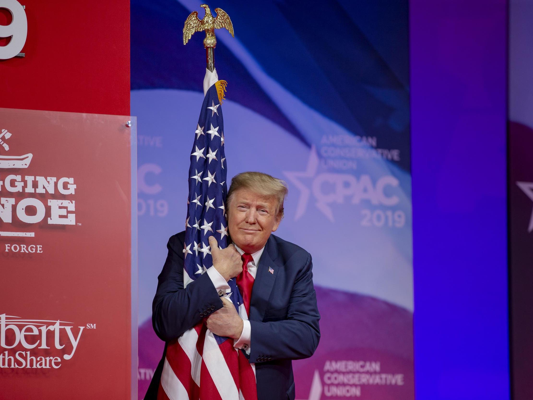 Donald Trump goes off track during his speech and hugs the flag instead